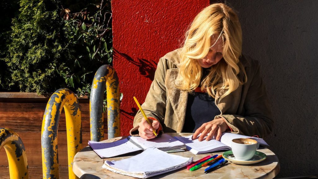 woman writing on book